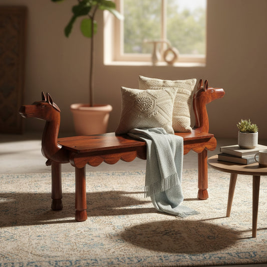 Vahana Carved Wooden Bench featuring intricate tribal handicraft, rich wooden finish, adorned with cozy cushions and a soft throw, ideal for stylish home decor.