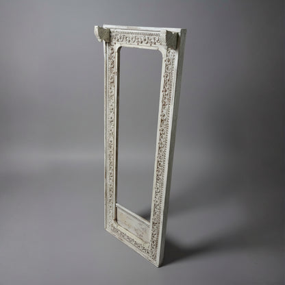 Ashva Wooden Mirror Frame in white with intricate carved wooden details, showcasing elegant handicraft decor ideal for adding a rustic, artistic touch to any space.