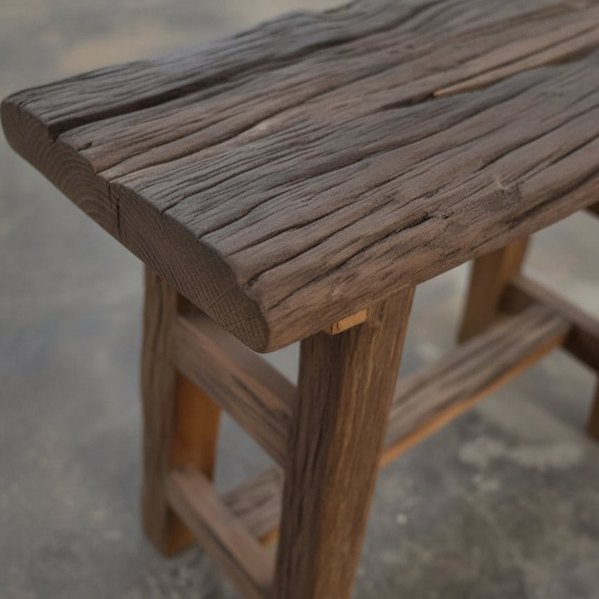 Close-up of a handcrafted wooden Chaupal Rustic Stool showcasing its textured, natural wood grain and sturdy construction, perfect for rustic decor and tribal handicrafts.