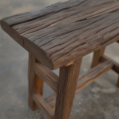 Close-up of a handcrafted wooden Chaupal Rustic Stool showcasing its textured, natural wood grain and sturdy construction, perfect for rustic decor and tribal handicrafts.