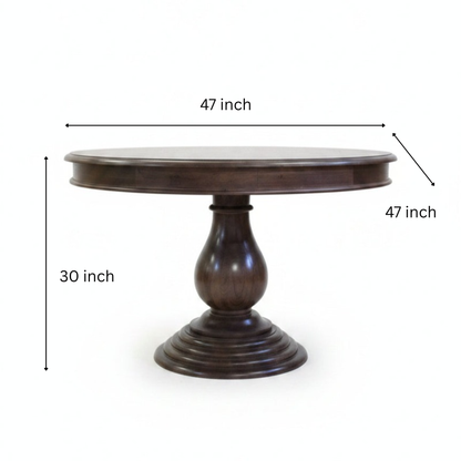 Elegant round wooden dining table with a polished dark finish, featuring a sturdy carved pedestal base, reflecting handcrafted tribal decor artistry.