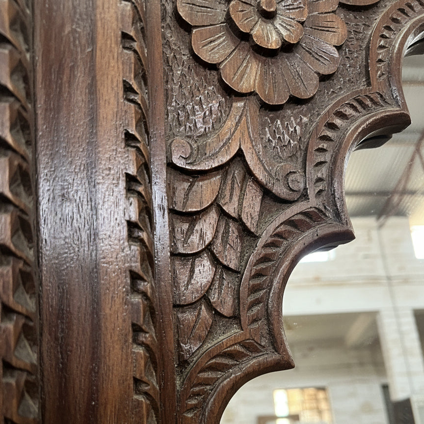 Hand-carved wooden frame with intricate floral and leaf tribal patterns