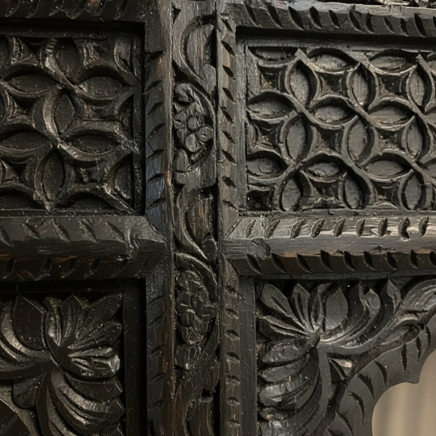 Close-up of the Jharokha Wall Hanging, featuring dark wood with intricate hand-carved floral and geometric patterns—showcasing deep grooves and remarkable craftsmanship, making it an exquisite piece of decor.