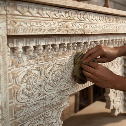 Hand finishing carved wooden furniture with whitewash tribal floral patterns