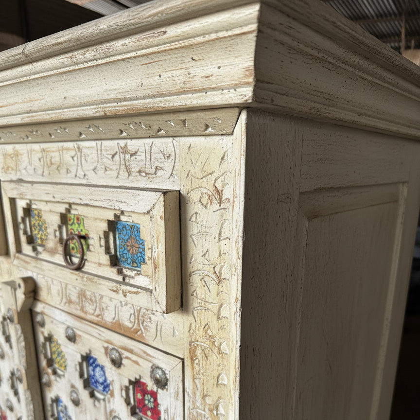 Handcrafted wooden cabinet with carved details and colorful ceramic tiles
