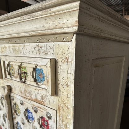 Handcrafted wooden cabinet with carved details and colorful ceramic tiles