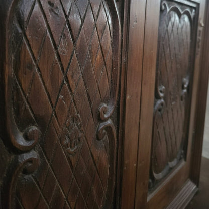 Hand carved wooden panel with tribal diamond patterns and floral motifs