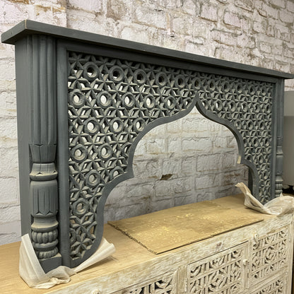 Handcrafted wooden arch frame with intricate geometric carvings, tribal decor accent
