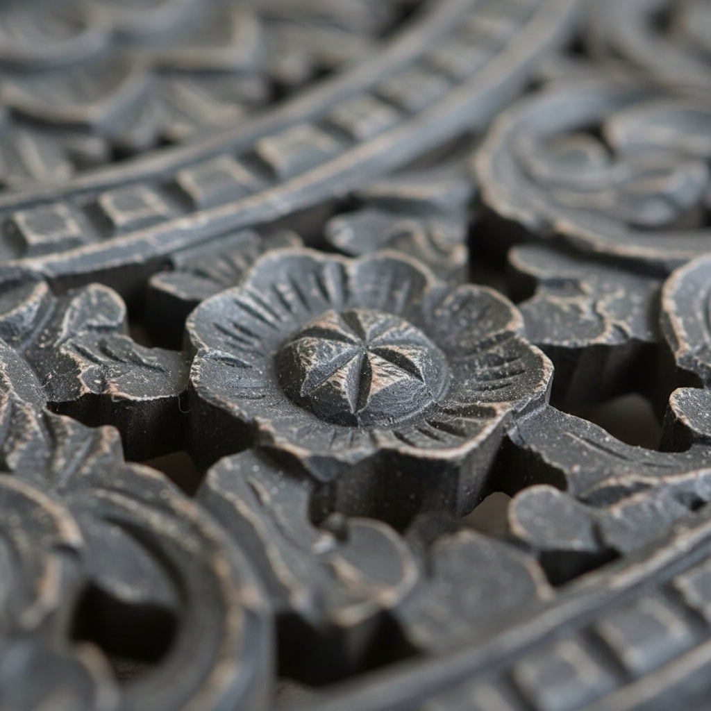 Close-up of intricate black wood floral carving, traditional handmade tribal decor