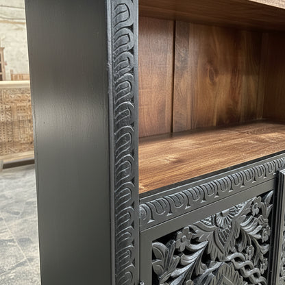 Hand-carved wooden cabinet with tribal patterns and dark wood finish