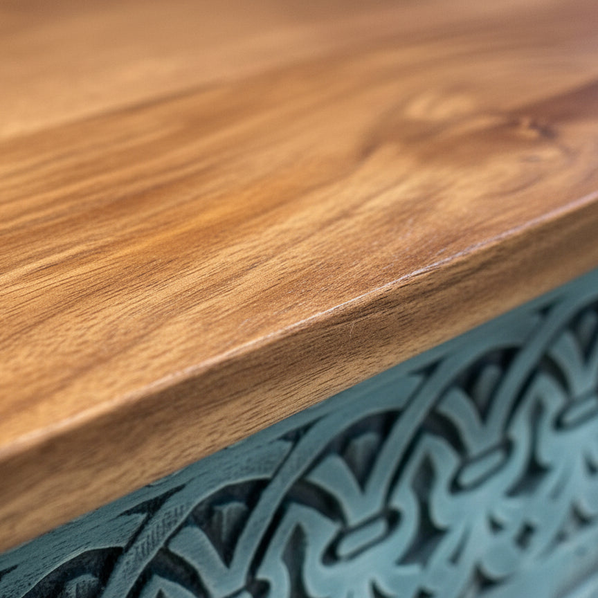 Close-up of the smooth wooden top and intricate hand-carved blue detailing of the Rani Carved Console Unit showcasing its elegant decor and craftsmanship.