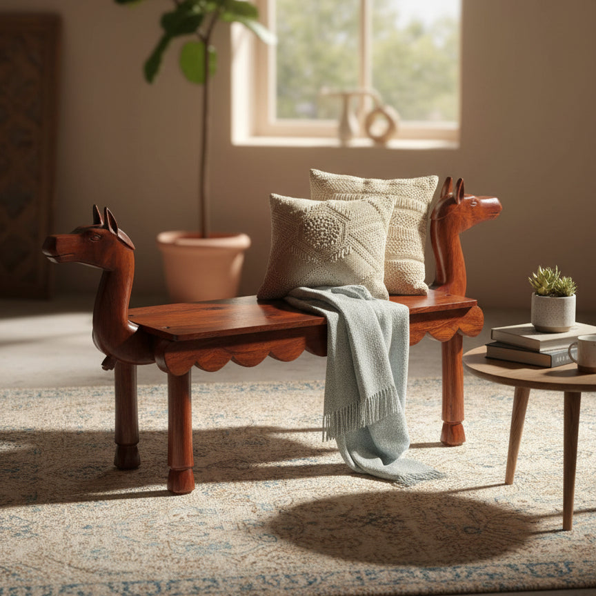 Vahana Carved Wooden Bench featuring intricate tribal handicraft, rich wooden finish, adorned with cozy cushions and a soft throw, ideal for stylish home decor.