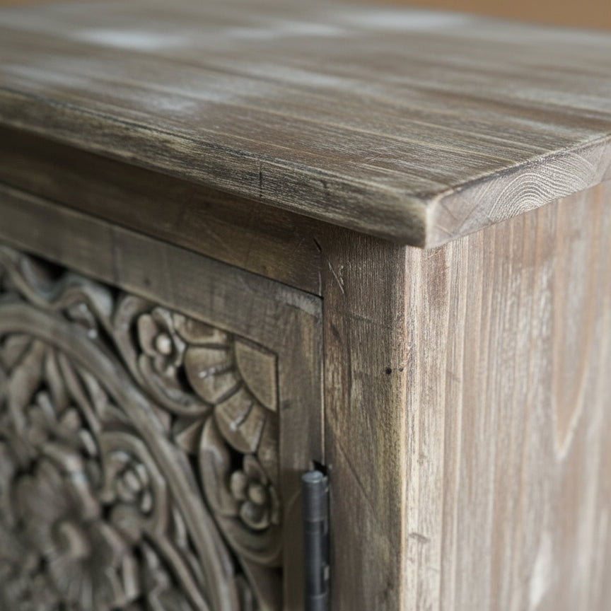Close-up of hand carved wooden cabinet with intricate floral tribal design