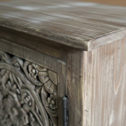 Close-up of hand carved wooden cabinet with intricate floral tribal design